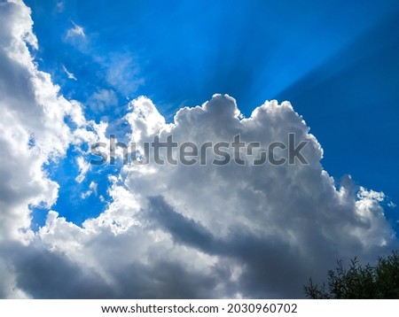 The sun's rays break through the dark clouds in the sky. Beautiful spectacular conceptual background of meditation. Beautiful sky.
