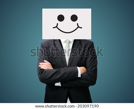 Businessman standing white paper happy smile face holding front of head on dark background