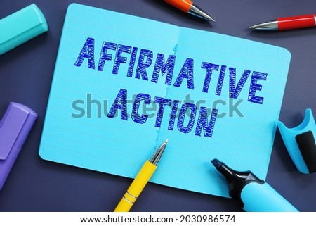 Business concept meaning Affirmative Action with inscription on the piece of paper. 
