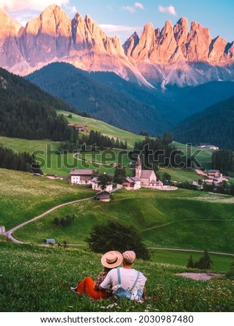 couple on vacation in the Italian Dolomites, Santa Maddalena Santa Magdalena village with magical Dolomites mountains in autumn, Val di Funes valley, Trentino Alto Adige region, South Tyrol, Italy Royalty-Free Stock Photo #2030987480