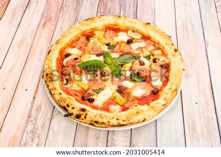 Whimsical Italian Pizza Recipe with Artichoke Hearts, Basil, Prosciutto, Black Olives, Mushrooms, and Mozzarella Cheese
