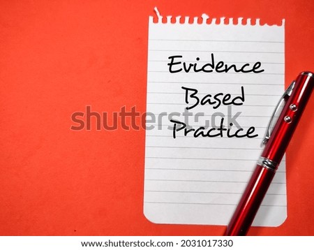Medical concept.Text Evidence Based Practice writing on notepaper with pen on a red background.