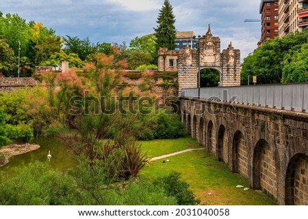 Taconera Gardens and Portal de la Taconera built in 1906 in Pamplona, Navarre, Spain on a cloudy day
