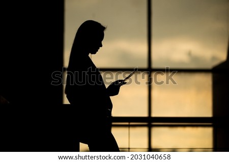 Portrait Of silhouette A middle-aged Asian woman Successful Business Woman Holding tablet In Hand at office