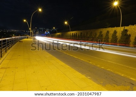 Long exposure of cars at night and city light and electricity light and yellow