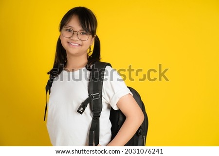 Smiling Asian little girl with glasses with school bag is back to school, Educational concept for school.