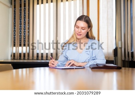 Positive female, interview candidate, signing apply for job at meeting room in office