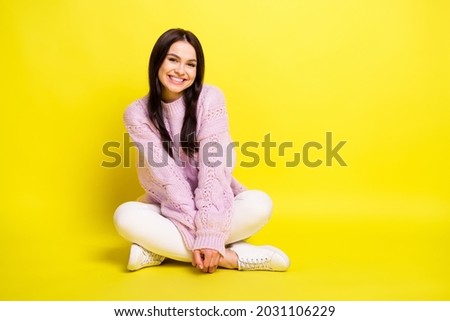 Full length photo of resting young lady sit wear sweater pants isolated on yellow color background