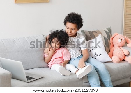 African-American children watching cartoons at home