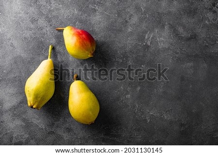 Three ripe pears on gray background top view, trending ugly fruits, copy space for text