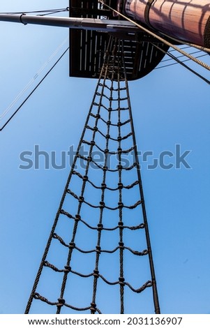 classic tall ship with rope rigging and sails. and crows nest Royalty-Free Stock Photo #2031136907