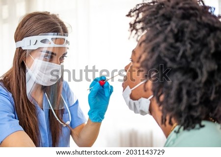 Doctor wearing personal protective equipment performing a Coronavirus COVID-19 PCR test, patient nasal NP and oral OP swab sample specimen collection process, viral rt-PCR DNA diagnostic procedure