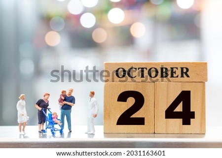 Miniature people Doctor and children on wooden block 24 october background . World Polio Day concept