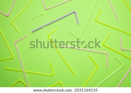 Colored cocktail tubes on a green background, festive background, invitation template, cheerful banner