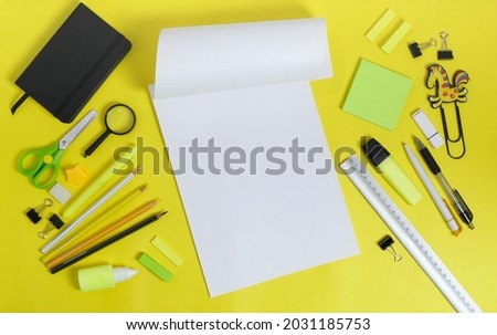 School or office workspace with stationery on yellow background. Flat lay, copy space for text.