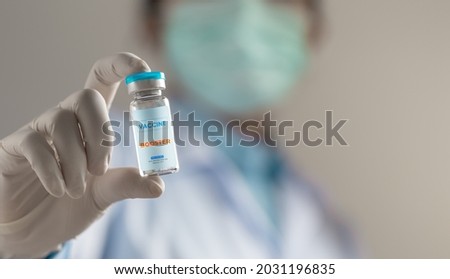 Doctor or scientist holding liquid vaccines booster. fight against virus covid-19 coronavirus, Vaccination and immunization. diseases,medical care,science, vaccine booster concept. Royalty-Free Stock Photo #2031196835