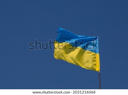 flag and coat of arms of Ukraine on sky background