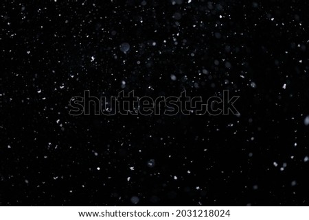 Real falling snow on black background for blending modes in ps. Ver 08 - few snowflakes in blur. Royalty-Free Stock Photo #2031218024