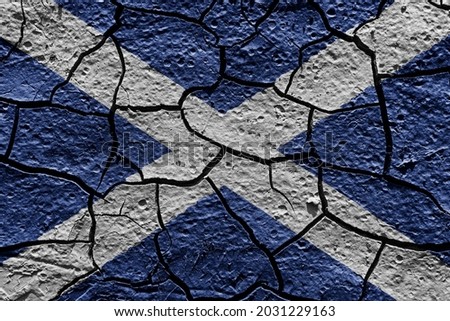 Scotland flag on a mud texture of dry crack on the ground