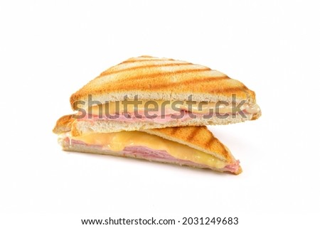  Pressed and toasted sandwich with ham and cheese on white background Royalty-Free Stock Photo #2031249683