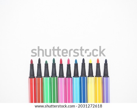 Close up color pen different array on white isolated top view copy space