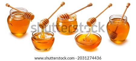 Honey jars, cups and dippers set isolated on white background. Package design elements with clipping path Royalty-Free Stock Photo #2031274436