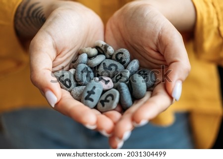 Numerology Numbers Concept. Numerology Calculate Life Path and Destiny Numbers. Many pebble stones with painted numbers in female palms Royalty-Free Stock Photo #2031304499