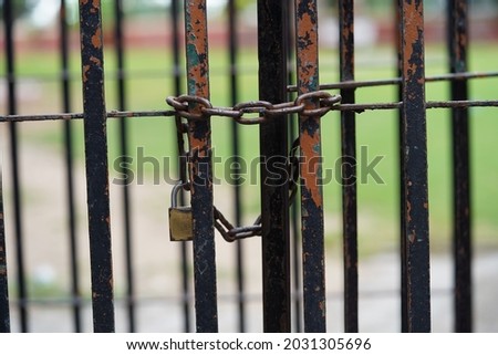 locked gate with old rustic lock and chain