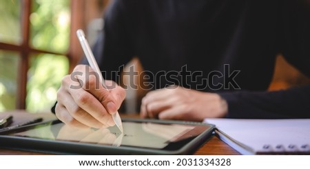 using professional digital tablet technology to write a business work, modern online screen cyberspace communication, hand writing via white pen, lifestyle same laptop computer or notebook using