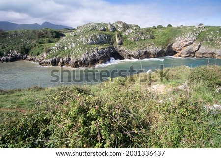 Llanes at North of Spain at Asturias region is an amazing place for enjoying the outdoors with amazing wild and green beaches like this panoramic view of Poo beach 