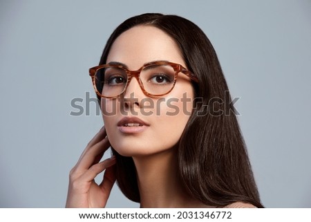 Stylish young brunette in a green dress and glasses, magazine cover, fashion industry, successful business woman. Royalty-Free Stock Photo #2031346772