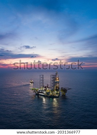 Offshore Jack Up Rig in The Middle of The Sea at Sunset Time for Petroluem Exploration and Production