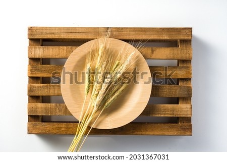 natural bamboo plate with ears of wheat, on wooden tray