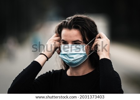 Woman Putting On medical protective mask,prevent coronavirus, medical mask,covid-19