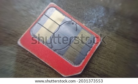 defocused abstract background of SIM card that has been damaged due to overheating on the table