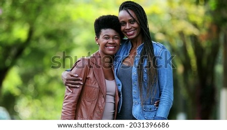 
Two African friends smiling at camera. Black women together