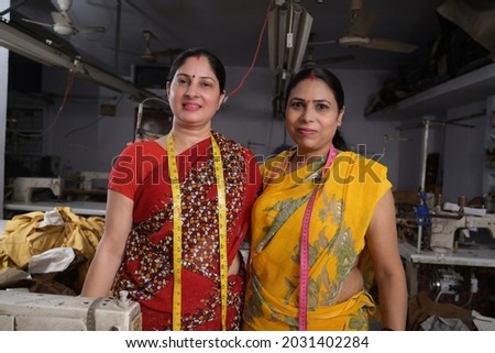 Two woman textile worker standing together