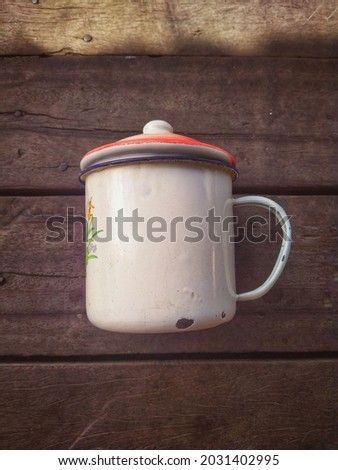 Vintage cup portrait on wooden background.  It is suitable for business, industry, company, icon, etc.