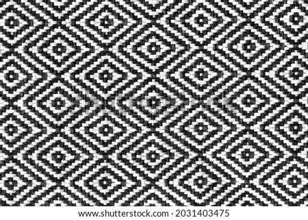 Rhombus - old ethnic canvas. Geometric ethnic pattern made with straw in black and white. knitting fabric pattern for background.