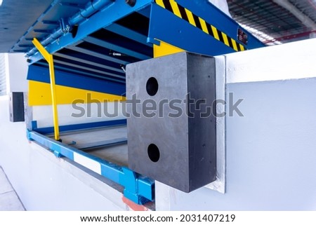 Loading dock leveler safety bumpers to keep trucks from harming the dock Royalty-Free Stock Photo #2031407219