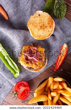 Hamburger with Cheddar Cheese and Caramelized Onions