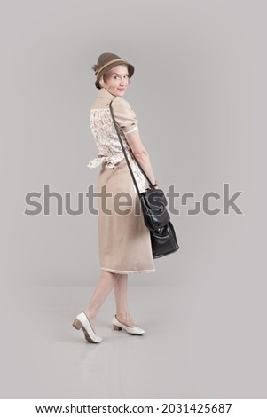Woman actor reenactor in historical clothes of the German fashion during 1940-1945 Royalty-Free Stock Photo #2031425687