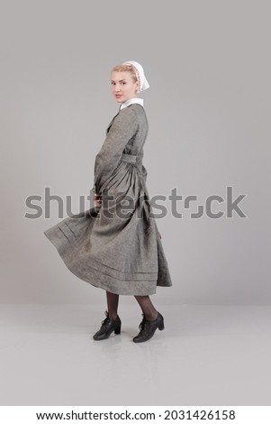 Woman actor reenactor in historical clothes nurse of the German fashion during 1940-1945 Royalty-Free Stock Photo #2031426158