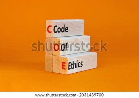 COE, Code of ethics symbol. Concept words 'COE, Code of ethics' on wooden blocks on a beautiful orange background. Business and COE, code of ethics concept. Copy space.