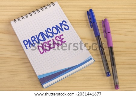 Conceptual caption Parkinson S Is Disease. Word for nervous system disorder that affects movement Multiple Assorted Collection Office Stationery Photo Placed Over Table