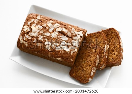 Banana bread is a type of bread made from mashed bananas. It is often a moist, sweet, cake-like quick bread. Selective focus. Top view. Isolated on white. Royalty-Free Stock Photo #2031472628