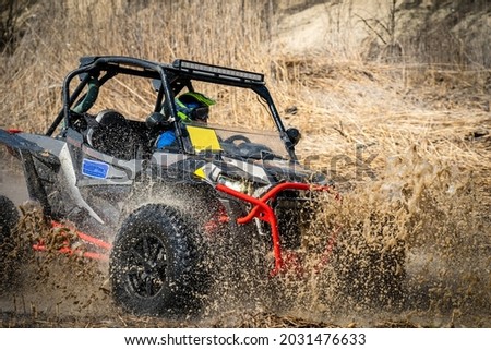 Active ATV and UTV Off-Road vehicle in muddy water. ATV 4x4 Royalty-Free Stock Photo #2031476633
