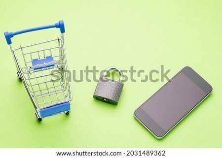 safe search and purchase, online business concept and online shopping security, lkx shopping basket magnifying glass and lock on a green background, a place for text