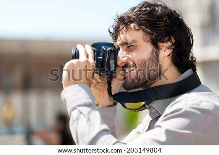 Male tourist taking picture in the city