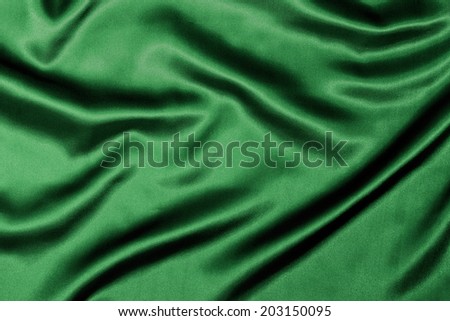 Green Silk background texture with wavy ripples to enhance the sheen of the fabric.